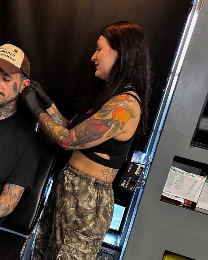 Mel piercing a client at New Identity Shirley